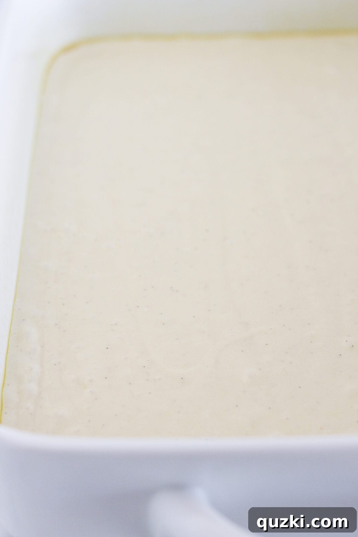 Perfect Vanilla Sheet Cake 5 Pouring the vanilla cake batter into a prepared 9x13 inch baking pan.