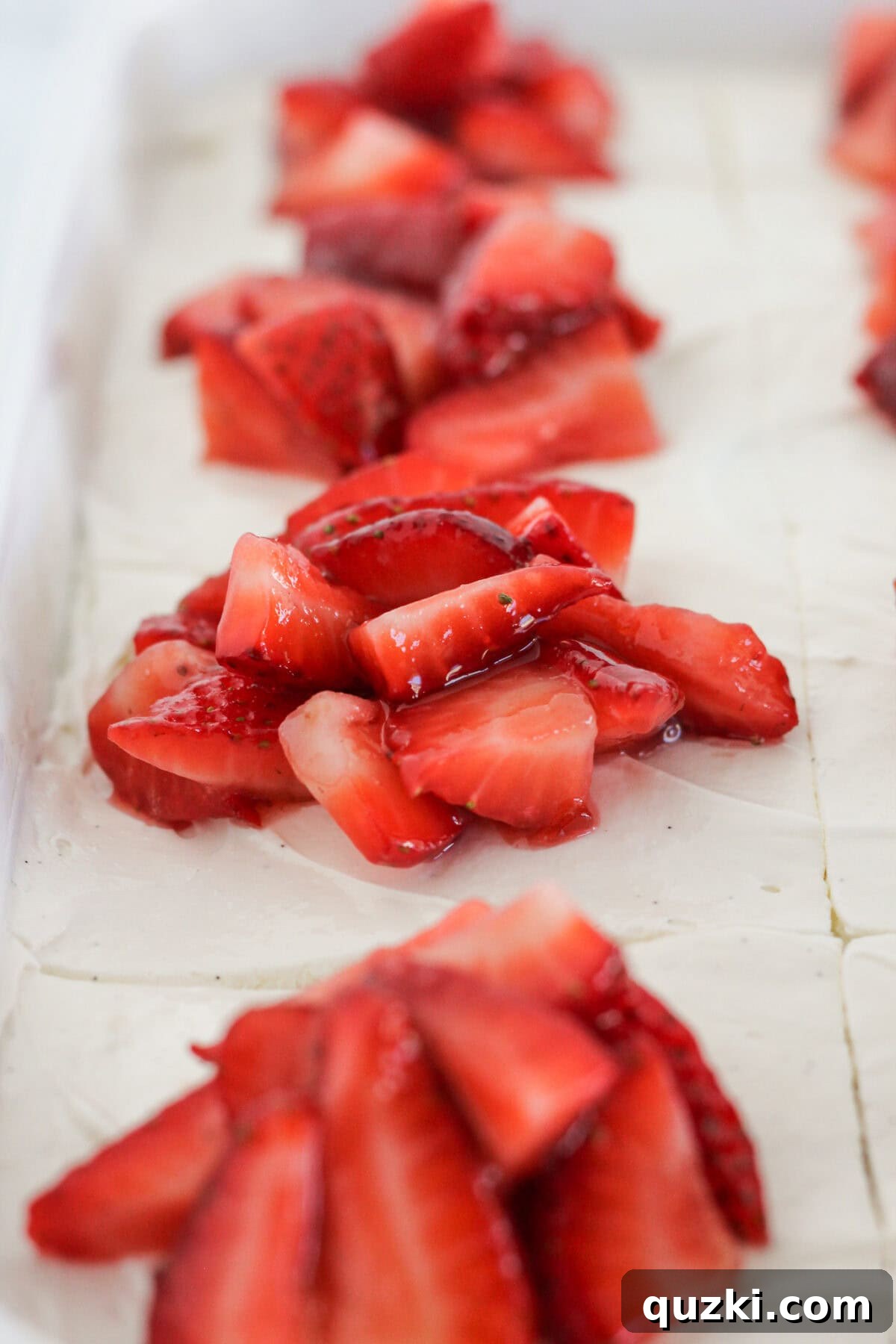 Perfect Vanilla Sheet Cake 9 Topping the frosted vanilla sheet cake with fresh sliced strawberries.