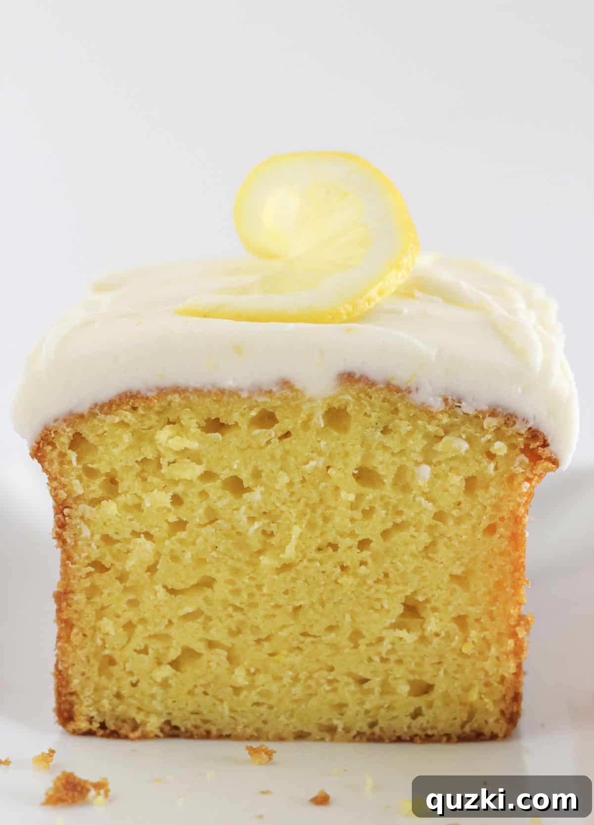 Sunshine Lemon Loaf 2 A beautifully frosted loaf of lemon bread, glistening with a vibrant lemon glaze.