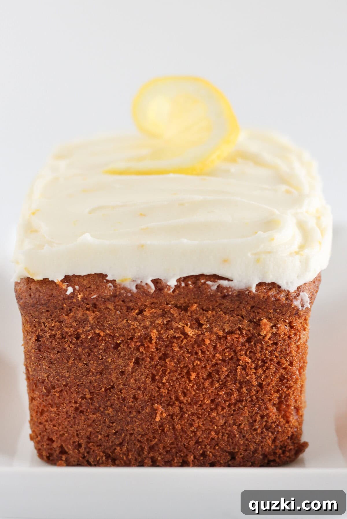 Sunshine Lemon Loaf 7 A freshly baked and beautifully frosted lemon loaf, sliced and ready to be enjoyed, showcasing its moist texture and vibrant glaze.