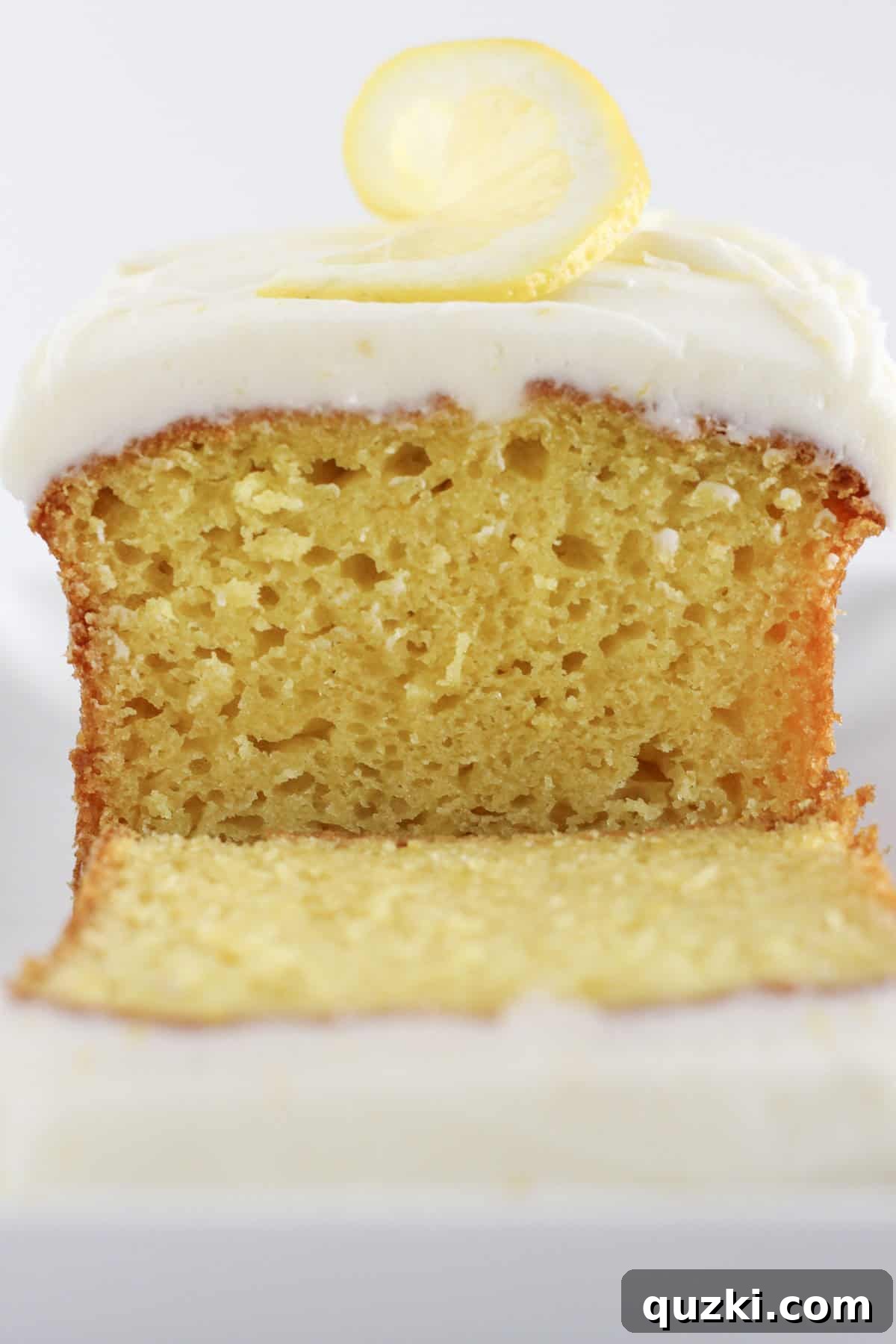 Sunshine Lemon Loaf 8 A close-up shot of a perfectly baked, unfrosted lemon bread loaf made with a cake mix, showing its golden crust and delicate texture.