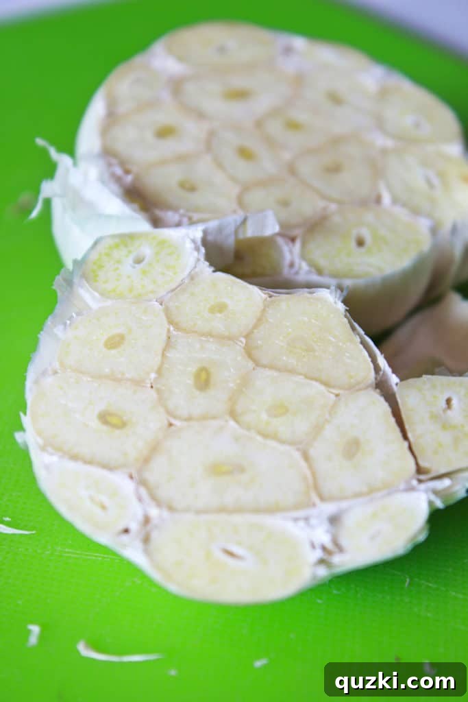 Halved head of garlic placed inside the chicken cavity.