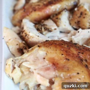 A whole slow cooker roasted chicken, golden brown and garnished.