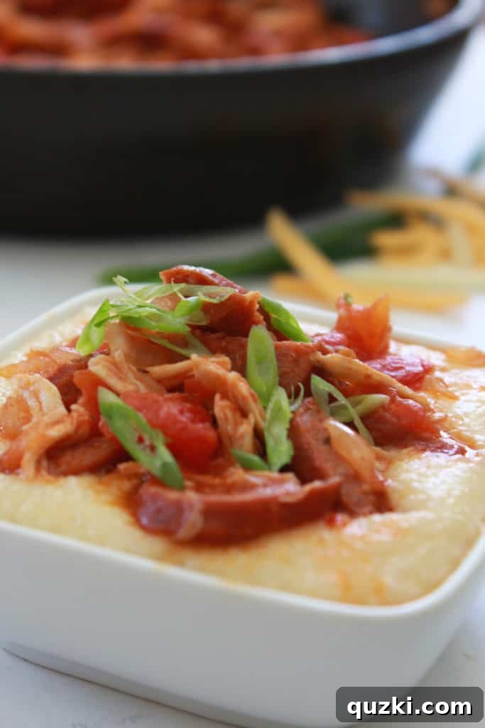 Fast and Flavorful 15-Minute Andouille Sausage Grits 8 A beautifully plated bowl of Cheesy Andouille Sausage and Grits, garnished with vibrant green onions, ready to be savored.