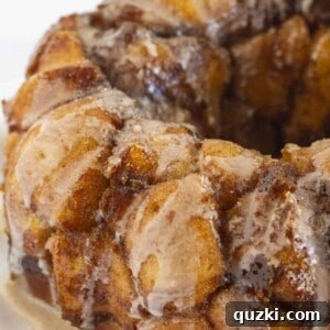 A close-up of a serving of delicious pumpkin monkey bread on a plate.