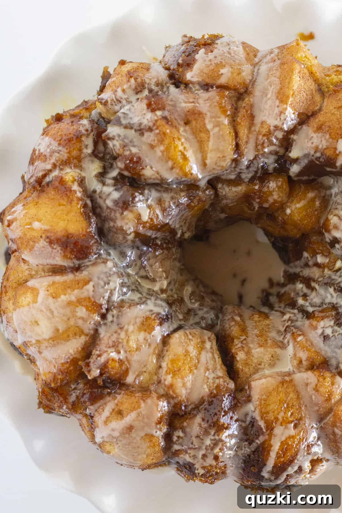 Heavenly Spiced Pumpkin Monkey Bread 8 An overhead view of a beautifully baked pumpkin monkey bread, glistening with glaze, ready to be pulled apart and enjoyed.