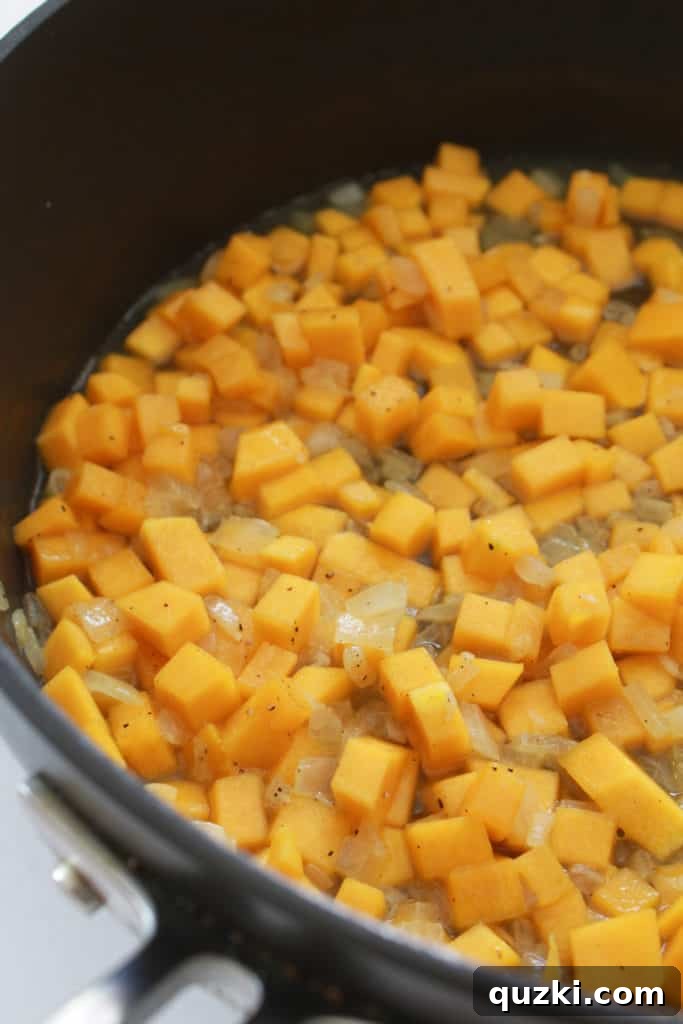 Golden Butternut Parmesan Pasta 4 Butternut squash, onions, and garlic cooking in a pan with broth, tenderizing the squash for blending.