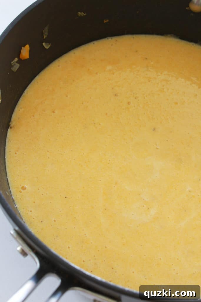 Golden Butternut Parmesan Pasta 7 Butternut squash sauce simmering gently in a pan on the stovetop, awaiting the final ingredients.