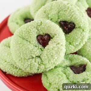 Grinch cake mix cookies on a red cake plate.