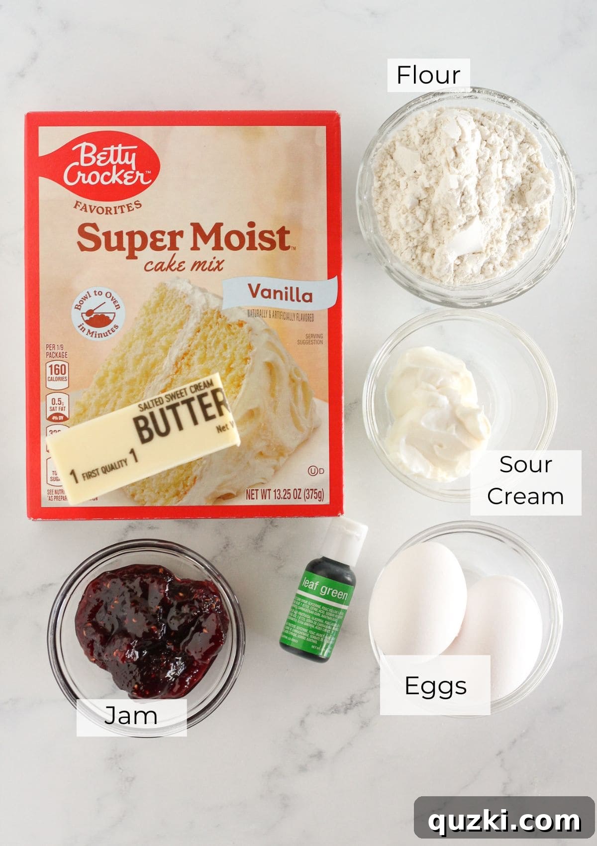The ingredients laid out for making Grinch Cake Mix Cookies, including cake mix, eggs, butter, sour cream, jam, and food coloring.