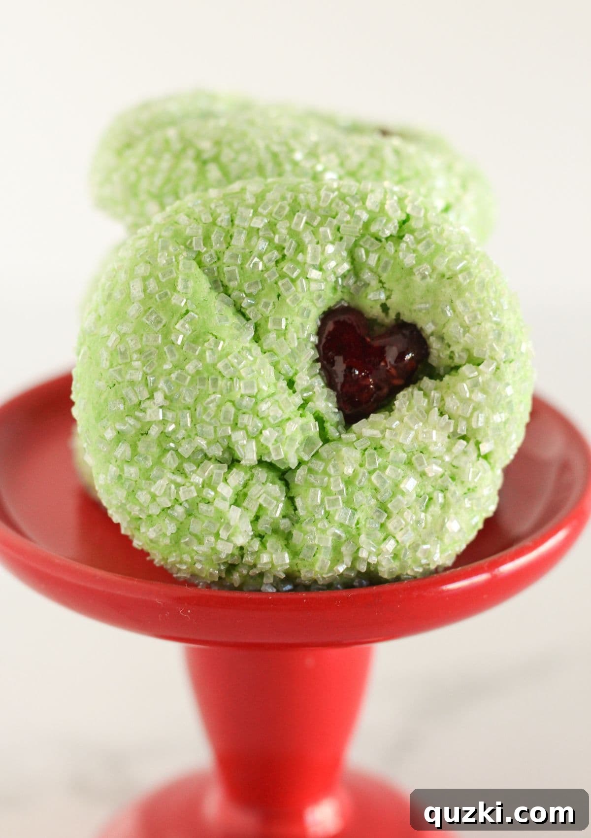 Four delicious Grinch Cake Mix Cookies arranged on a small red serving tray.