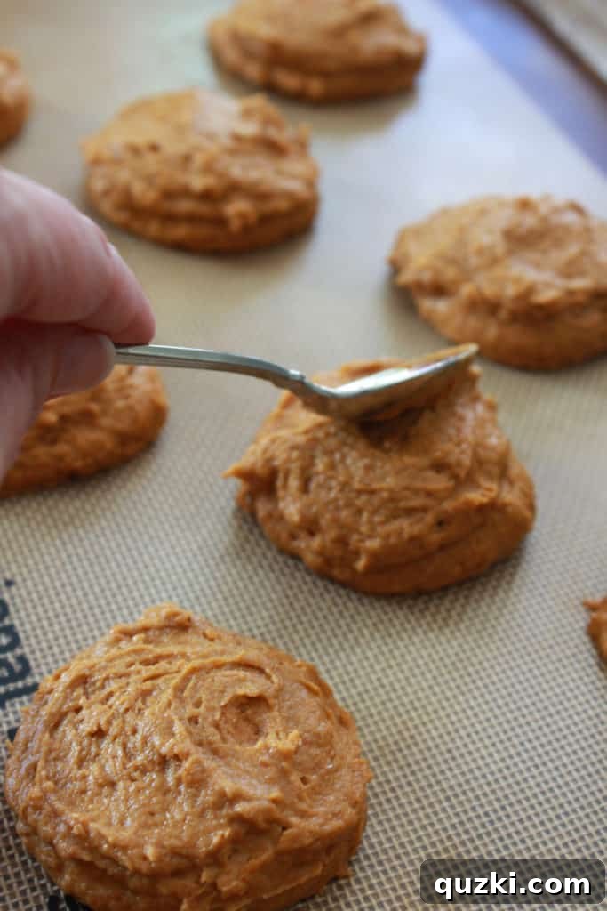 Pumpkin Swirl Cookies 6 Covering the cream cheese frosting ball with more pumpkin cookie dough before baking.