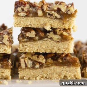 Pecan Shortbread bars stacked on each other, showcasing their rich texture.
