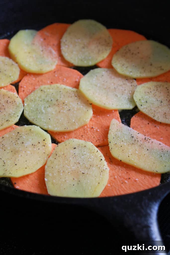 Creamy Sweet and Yukon Gold Potato Skillet Gratin 5 Layering thinly sliced sweet potatoes and Yukon Gold potatoes in a cast iron skillet for gratin