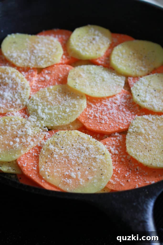 Creamy Sweet and Yukon Gold Potato Skillet Gratin 6 Adding grated Parmesan cheese between layers of sweet and Yukon Gold potatoes