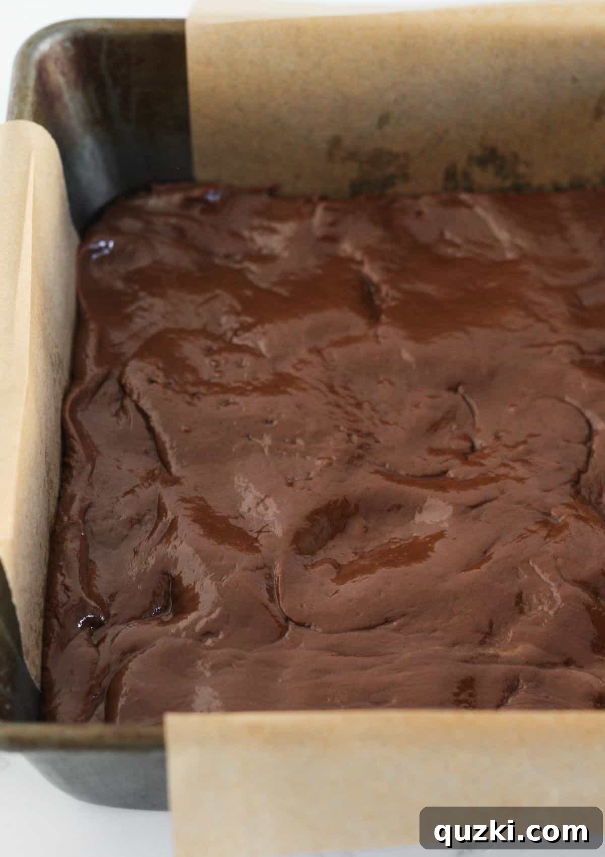 Seasonal Stacked Fudge Bliss 5 The rich chocolate fudge layer evenly pressed into the prepared 8x8 inch pan.