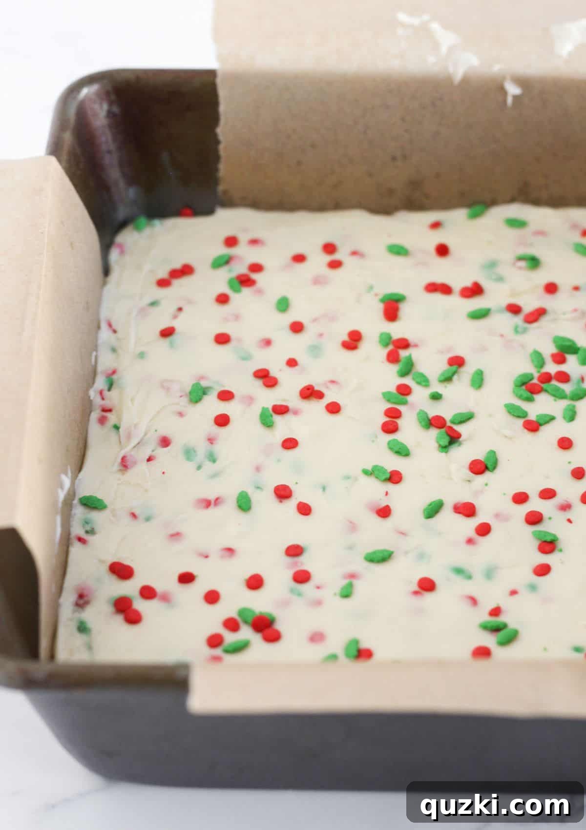 Seasonal Stacked Fudge Bliss 7 The vibrant white chocolate fudge layer with holiday sprinkles beautifully spread over the dark chocolate base.