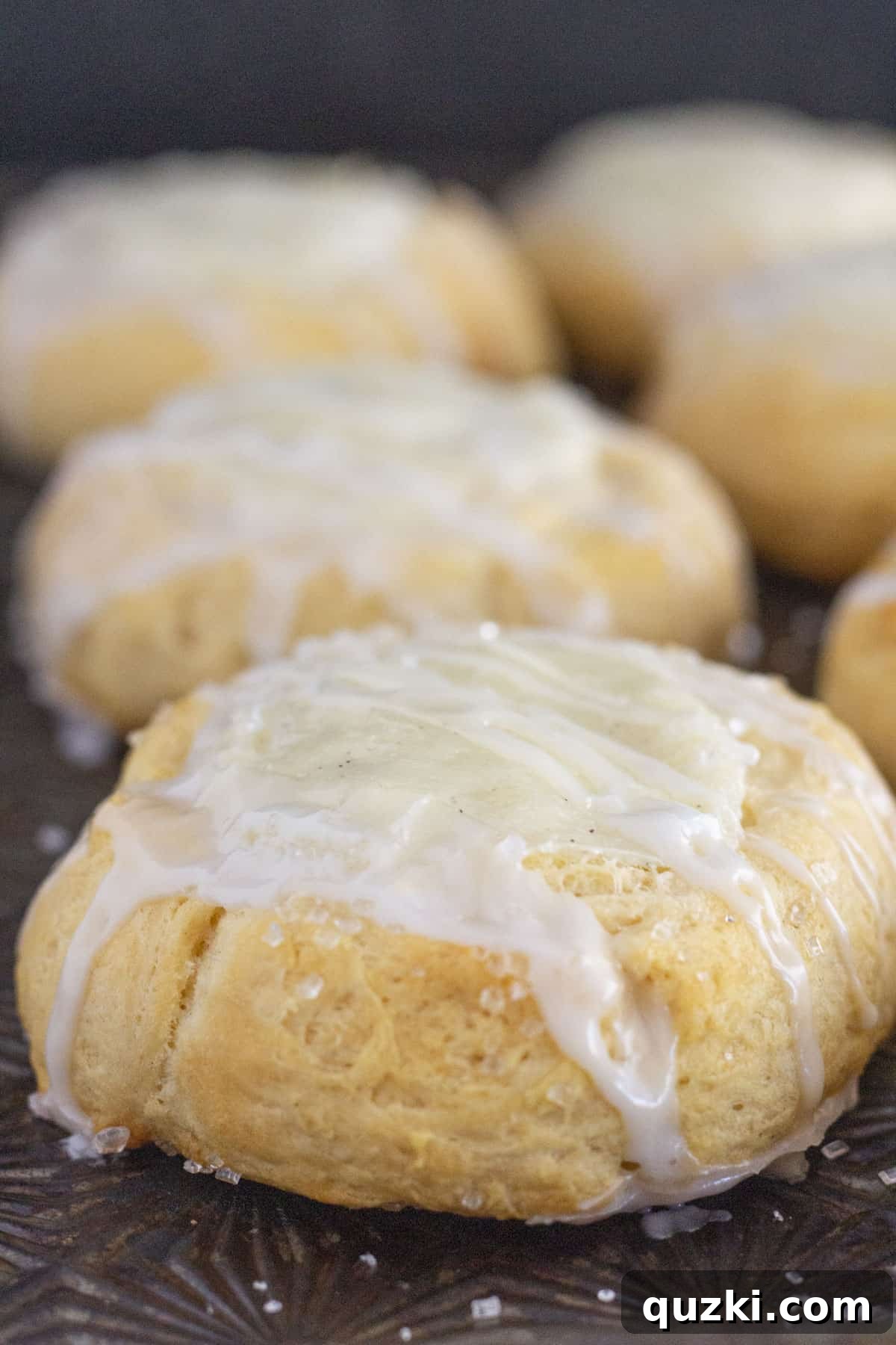 A tray of freshly baked crescent roll cream cheese danishes, golden brown and flaky.
