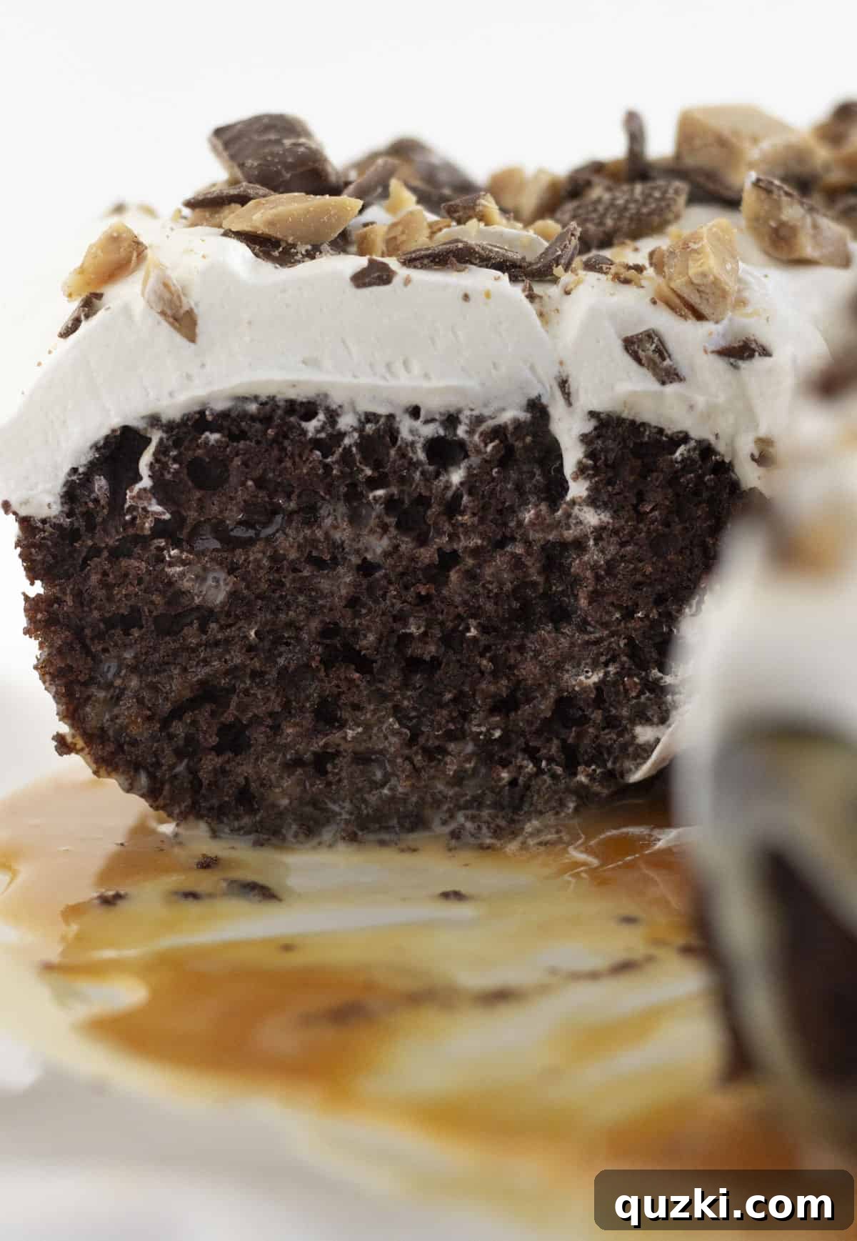 Pure Chocolate Bliss Cake 8 A close-up view of a Better Than Anything Chocolate Cake after a few slices have been served, revealing its moist interior and layers of topping.