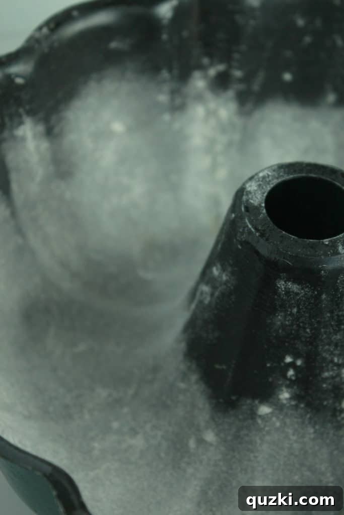 Decadent Black Bottom Bundt Cake 3 Bundt pan properly greased and floured, ready for Black Bottom Bundt Cake batter, ensuring easy cake release