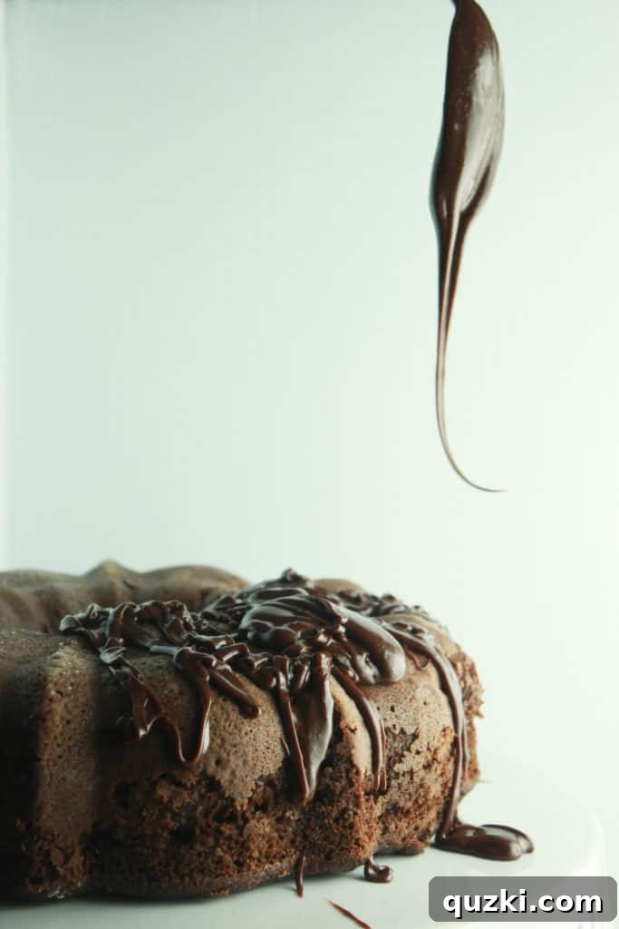 Decadent Black Bottom Bundt Cake 8 Smooth, glossy chocolate frosting being drizzled over a Black Bottom Bundt Cake for a perfect and appetizing finish