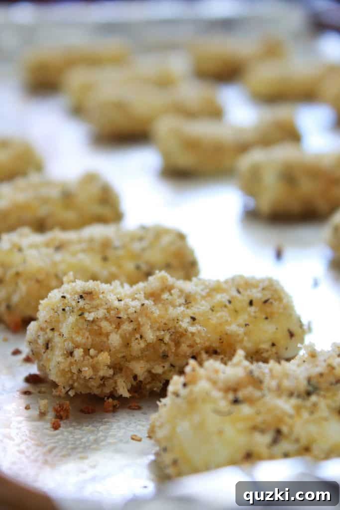 Freshly baked mozzarella sticks with golden-brown crusts, steaming hot and ready to be served.