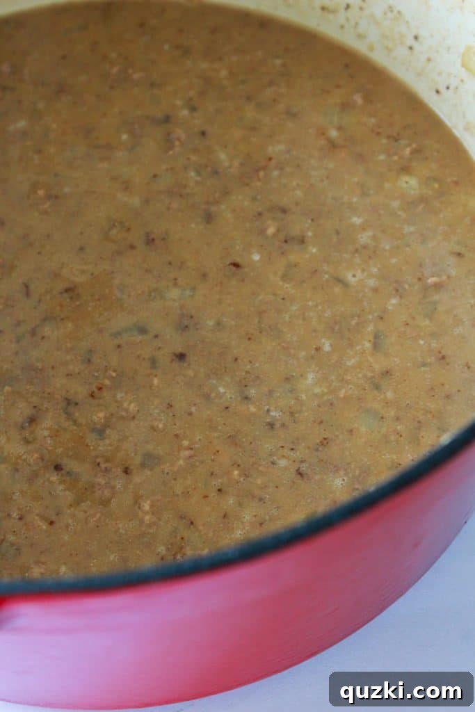 Adding black beans, tomato sauce, and Rotel to the chili pot.