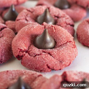Red Velvet Kiss Cookies on a white tray, showcasing their vibrant color and chocolate topping.