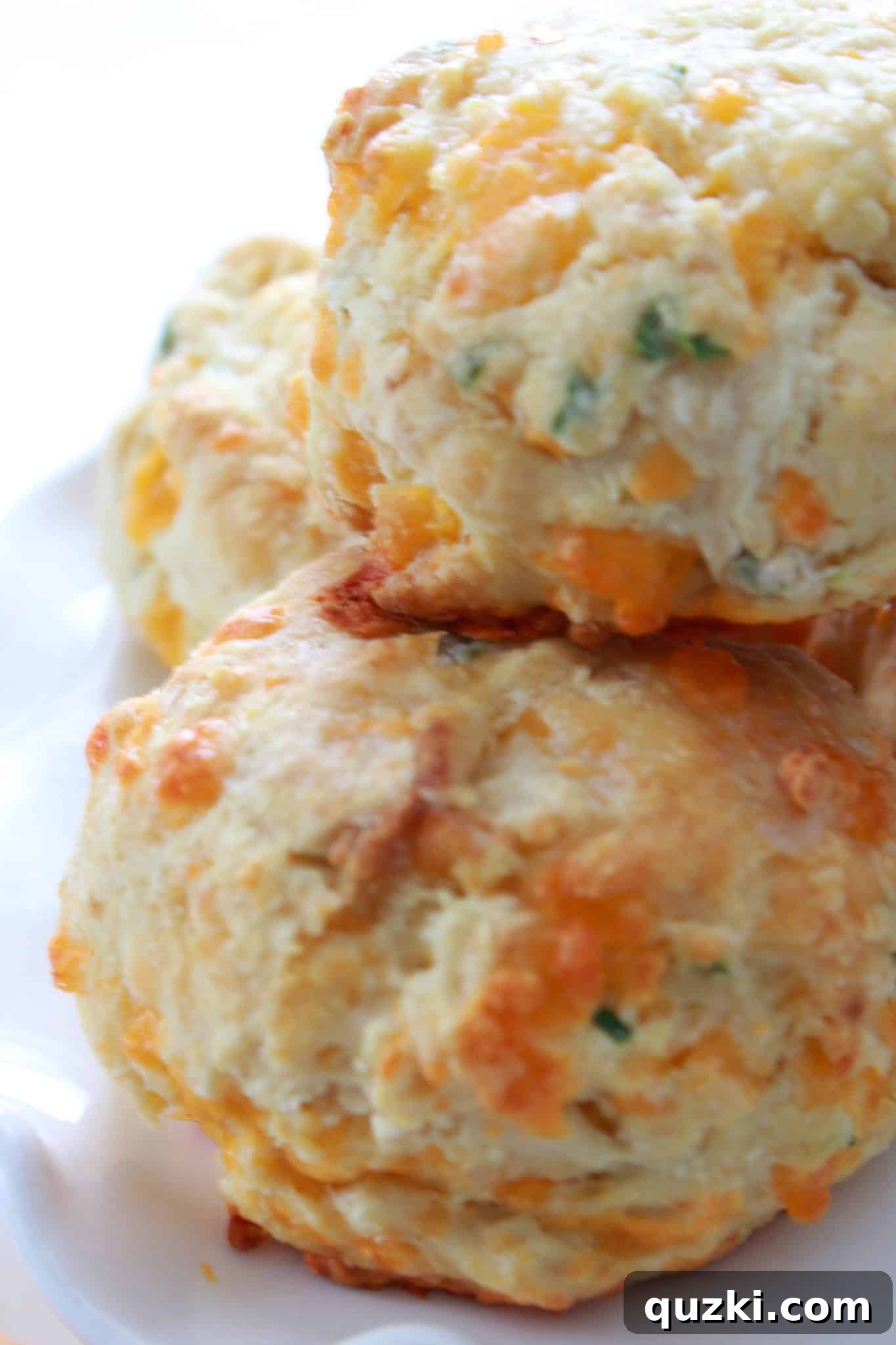 A serving tray filled with freshly baked cheddar and chive mini Irish soda breads, ready for guests.