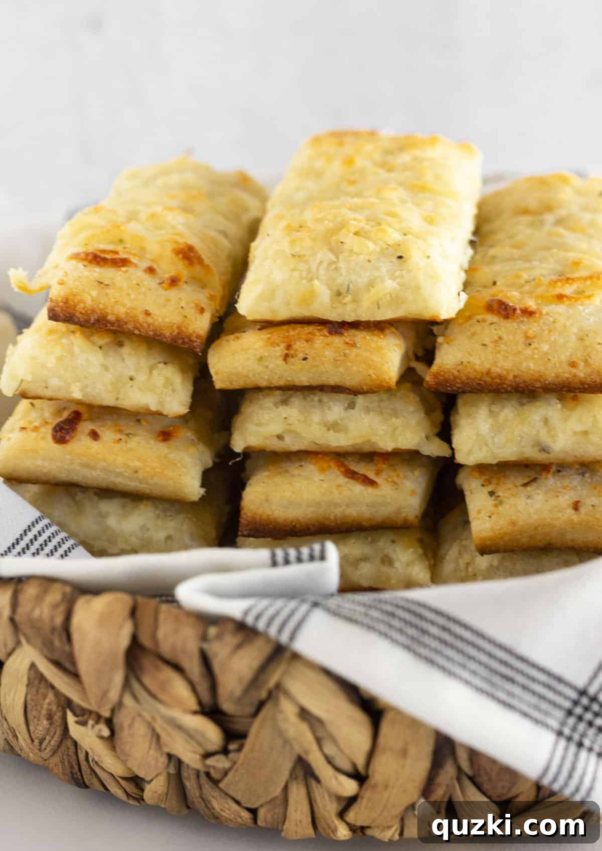 Melt-in-Your-Mouth Cheese Sticks 7 A charming basket overflowing with freshly baked, golden, and cheesy breadsticks, ready to be enjoyed.
