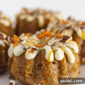 Mini carrot bundt cakes on a white cake plate, ready to be served.