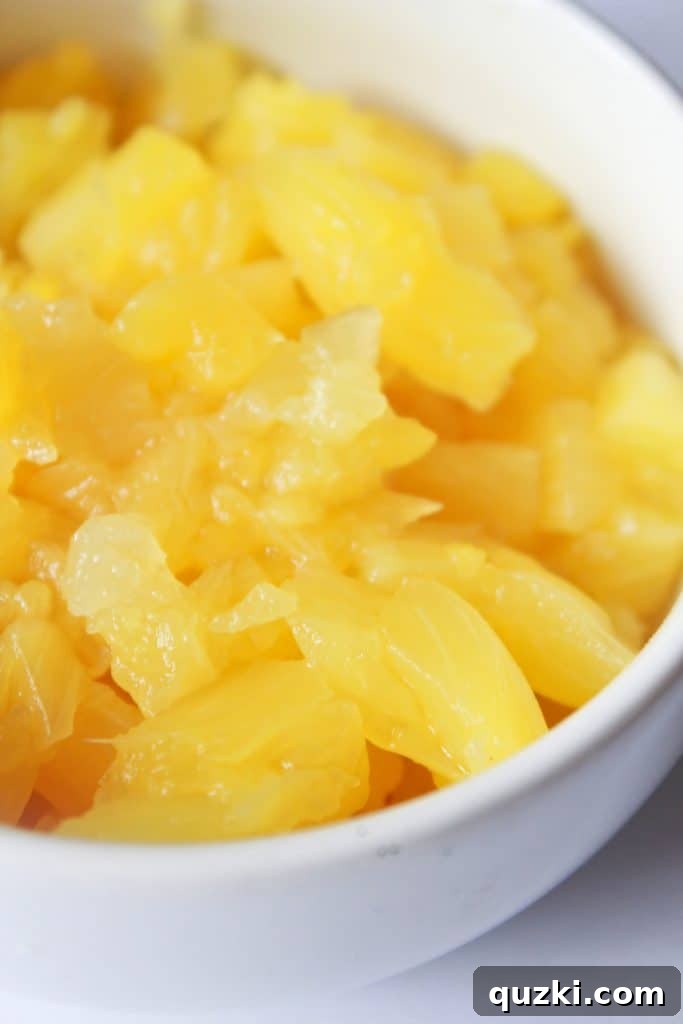 Freshly chopped pineapple tidbits, drained and ready to enhance the flavor of the teriyaki chicken casserole.