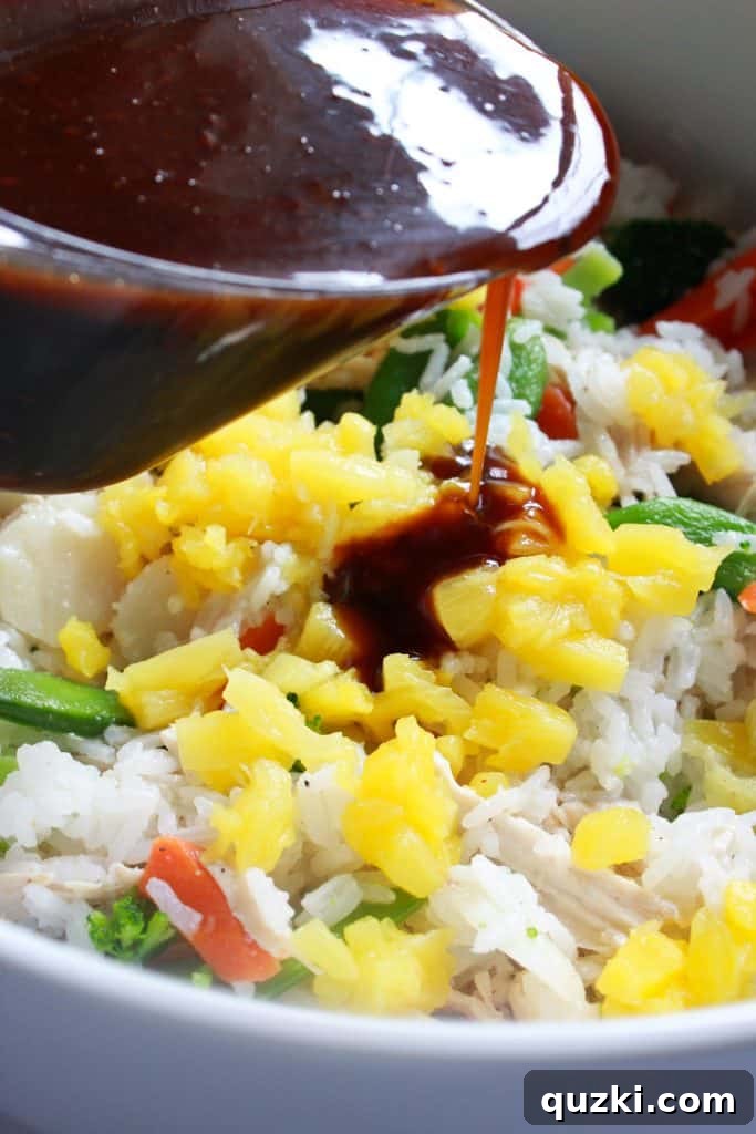 The casserole mixture, now enhanced with pineapple and most of the teriyaki sauce, being stirred for an even flavor distribution.