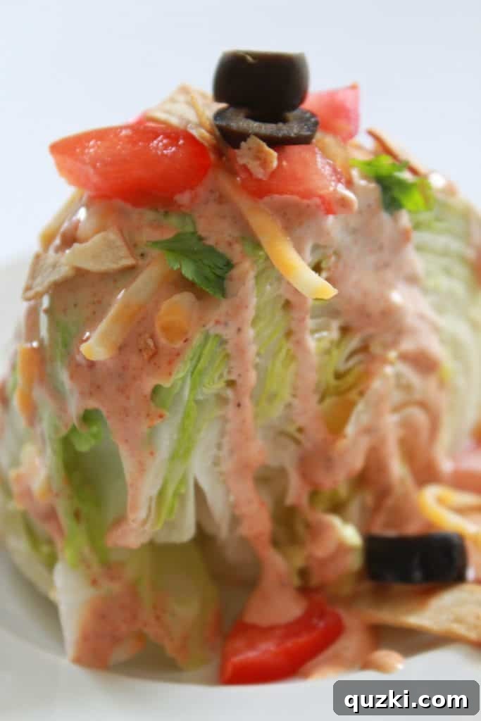Vibrant Fiesta Wedge Salad 12 A beautifully assembled Fiesta Wedge Salad, brimming with colorful toppings and dressing, ready to be served at a summer gathering or for Cinco de Mayo celebrations.