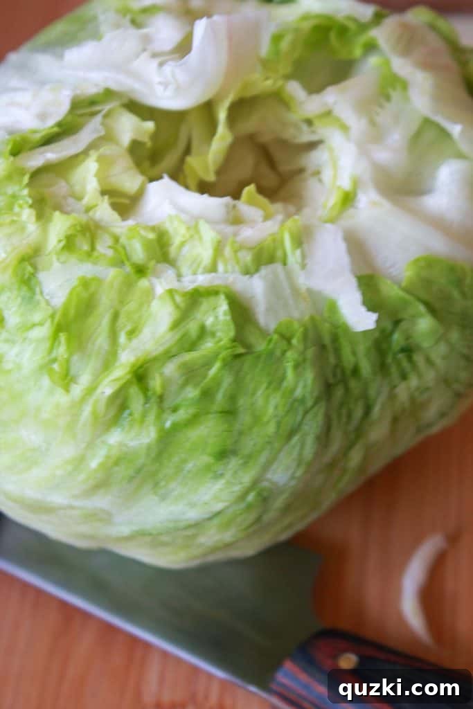 Vibrant Fiesta Wedge Salad 3 Step-by-step guide: removing the core from a head of iceberg lettuce for a wedge salad, ensuring a clean cut.