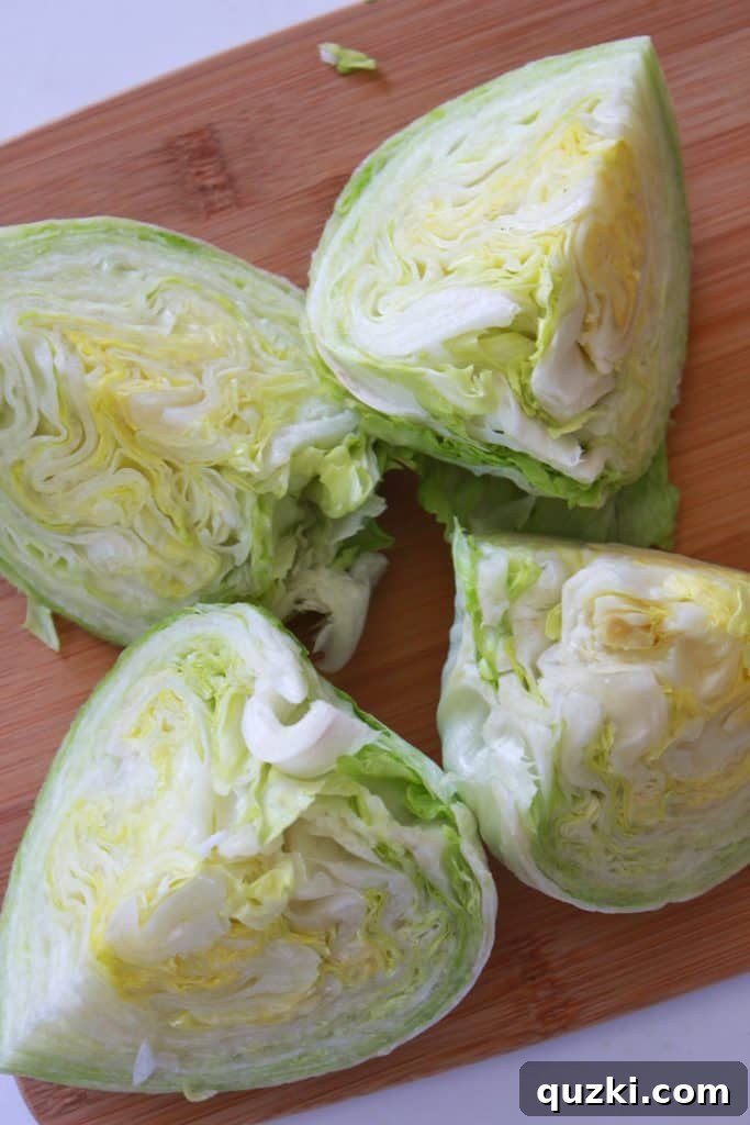 Vibrant Fiesta Wedge Salad 4 Iceberg lettuce head expertly cut into four equal wedges, prepared for assembly into a delicious Fiesta Wedge Salad.