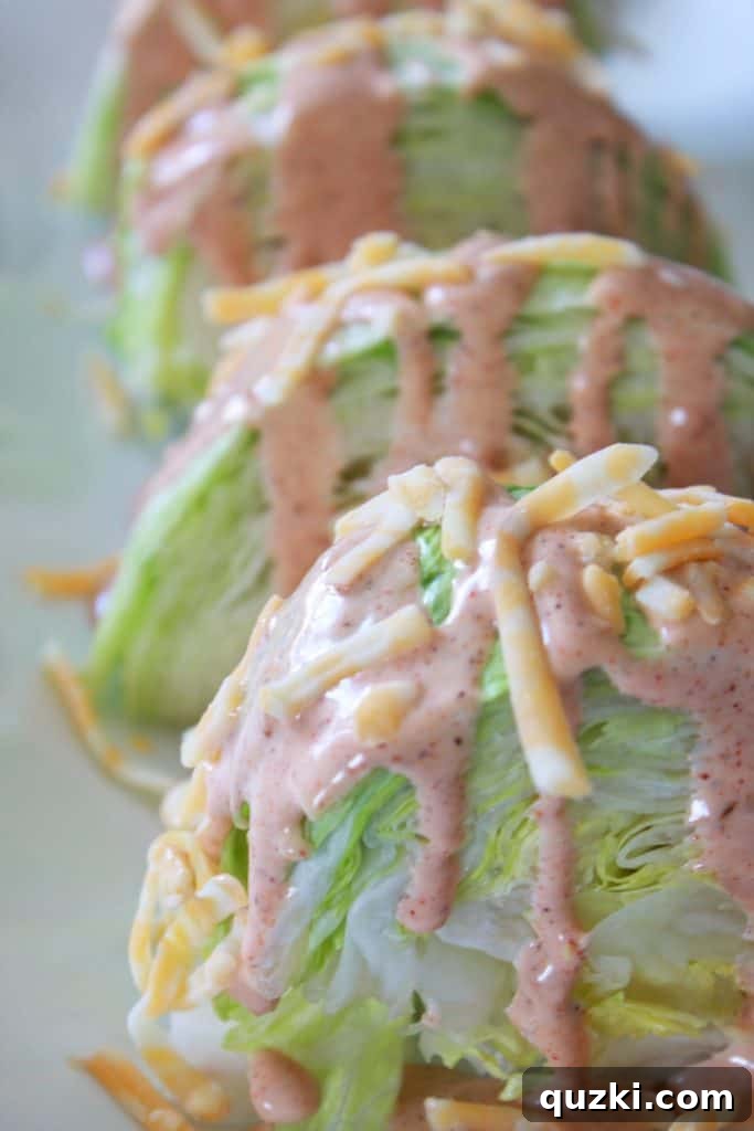 Vibrant Fiesta Wedge Salad 7 Shredded Colby Jack cheese liberally sprinkled over a dressed iceberg lettuce wedge, adding a rich, creamy layer to the Fiesta Wedge Salad.