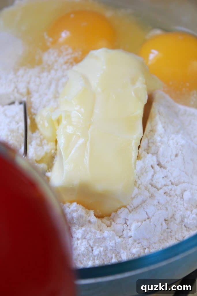 Effortless Boston Cream Pie Cookie Treats 5 Mixing cake mix, butter, and eggs for Boston Cream Pie Cookie Bites