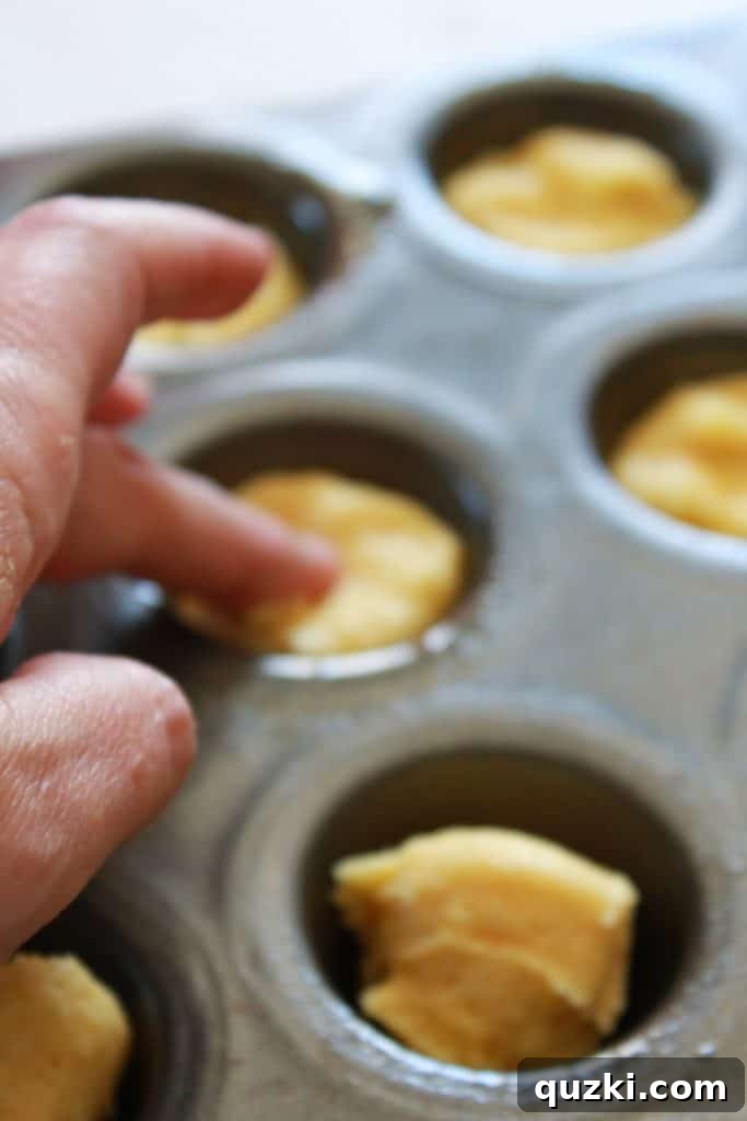 Effortless Boston Cream Pie Cookie Treats 7 Portioning cookie dough into greased mini muffin cups