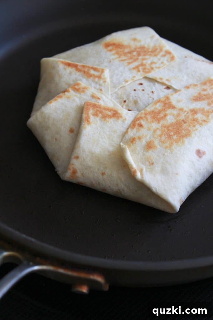 Golden Crunch Pocket 12 Step 9: Flipping the Crunchy Wrap after one side is golden brown and crispy, to cook the other side.