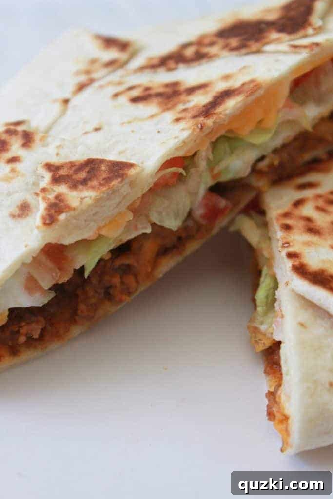 Golden Crunch Pocket 13 Close-up of a freshly cooked homemade Crunchy Wrap Supreme, showing the crispy tortilla and melted cheese.