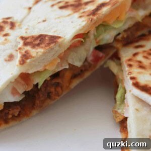 Golden Crunch Pocket 15 A top-down view of a delicious Homemade Crunchy Wrap Supreme on a plate.