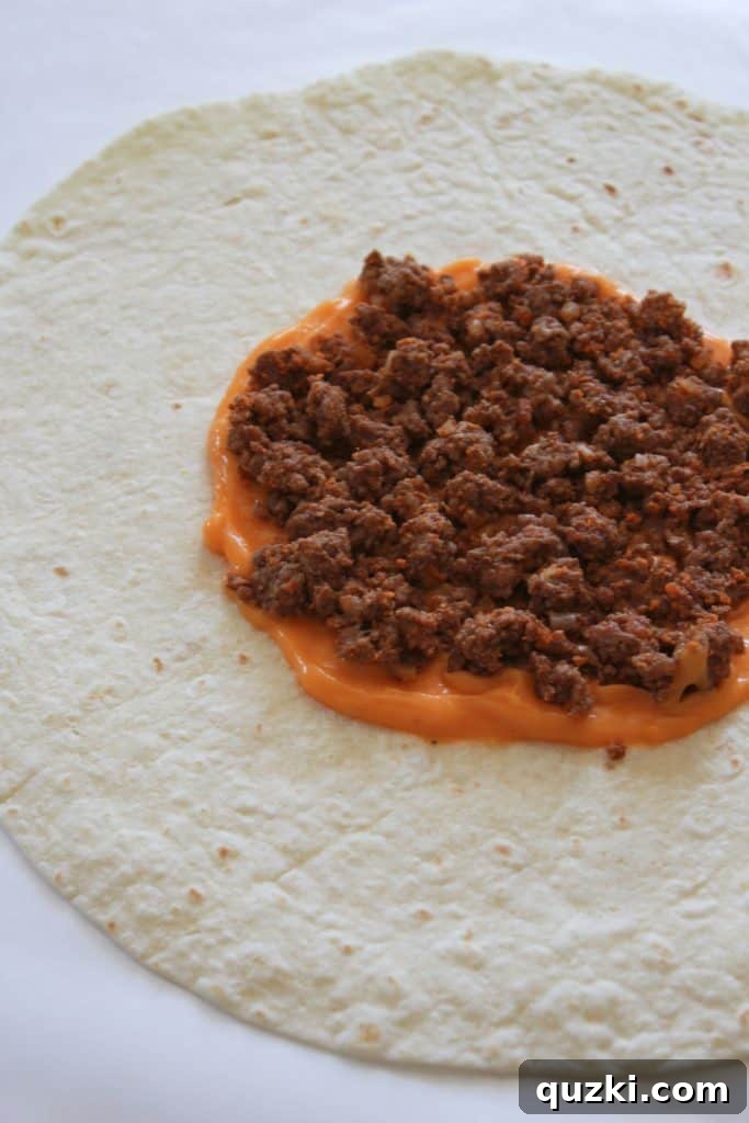 Golden Crunch Pocket 5 Step 2: Layering seasoned cooked ground beef on top of the nacho cheese sauce.