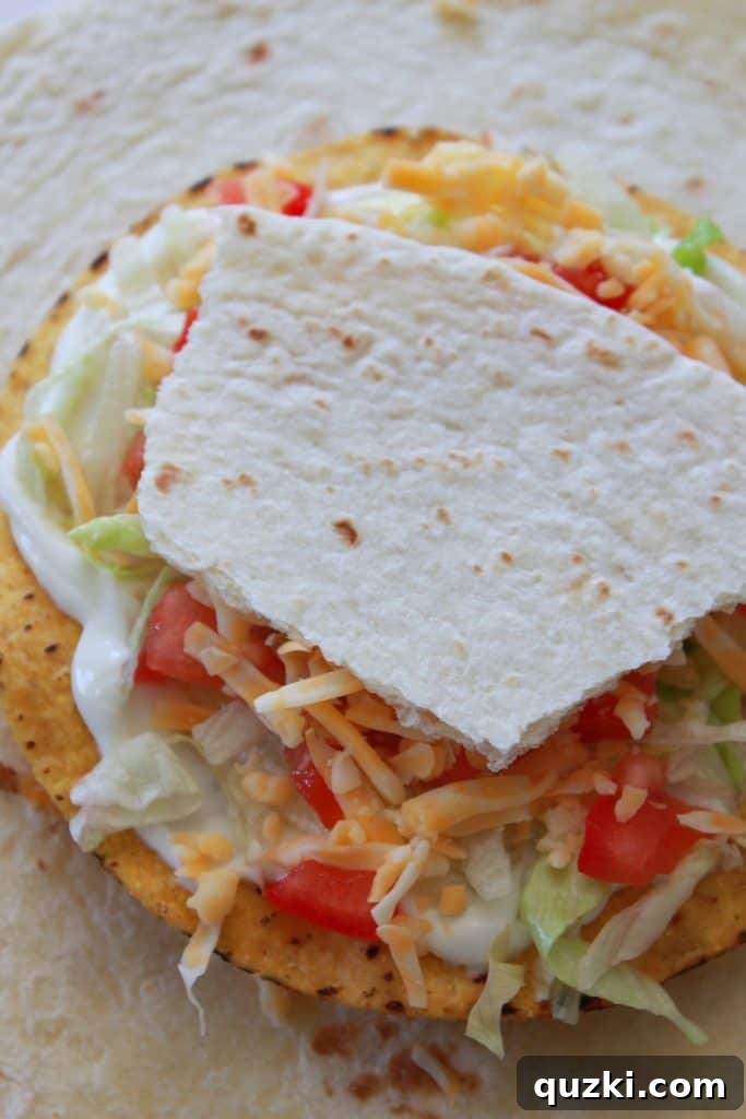 Golden Crunch Pocket 8 Step 5: Topping the fresh ingredients with shredded cheese and a torn piece of flour tortilla.