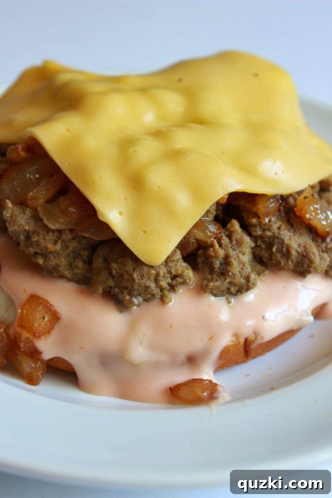 Slice of American cheese melting on the sloppy joe