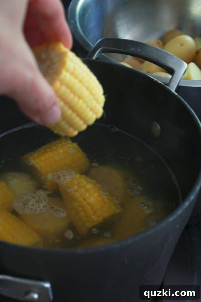Ultimate Sheet Pan Shrimp Boil 5 The vibrant ingredients of the Sheet Pan Cajun Shrimp Boil recipe, showcasing sliced andouille sausage alongside freshly boiled corn and potatoes.
