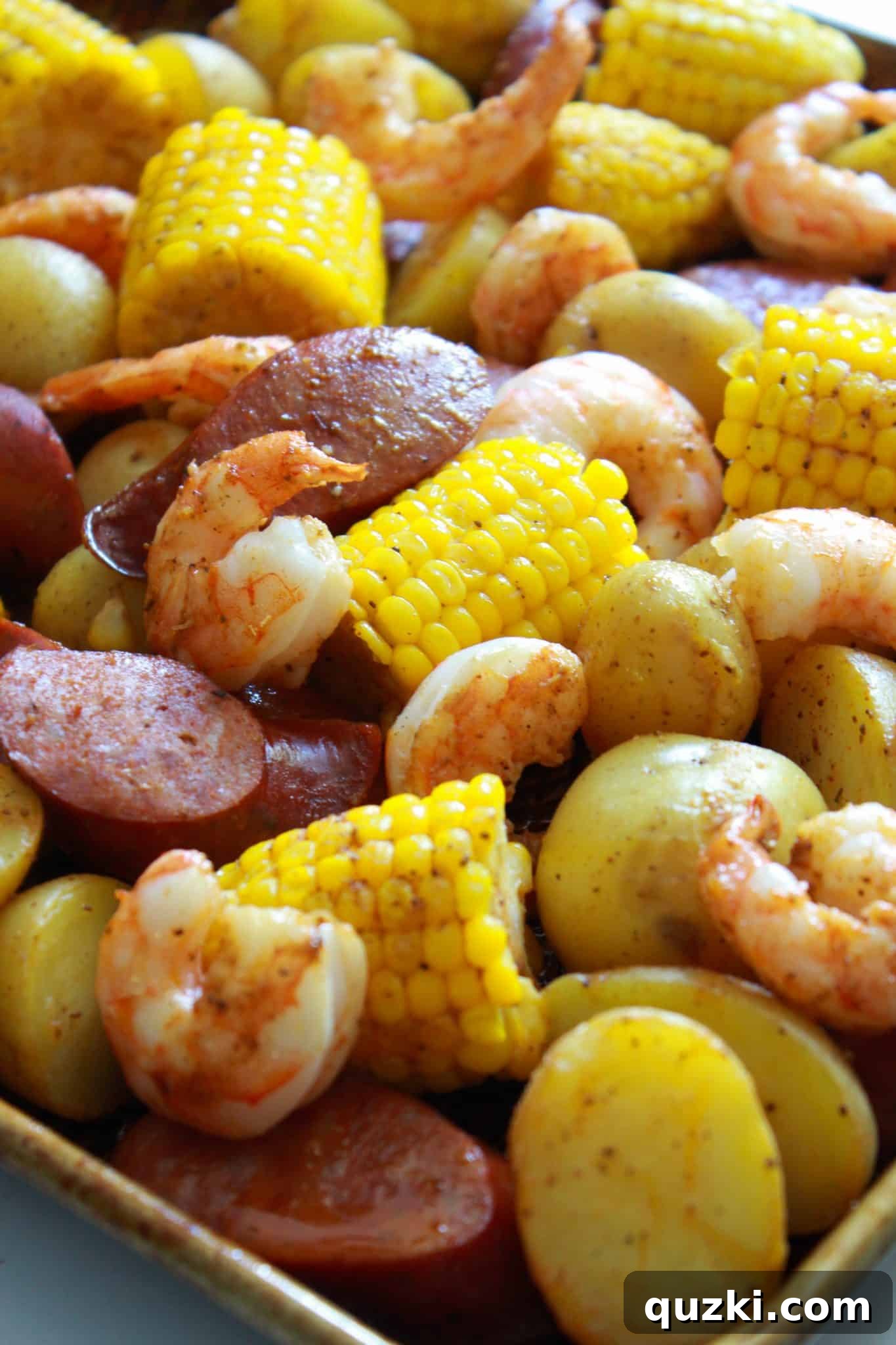 Ultimate Sheet Pan Shrimp Boil 10 A side-by-side comparison of the Sheet Pan Cajun Shrimp Boil before and after baking, showcasing the transformation of raw ingredients to a cooked, flavorful meal.