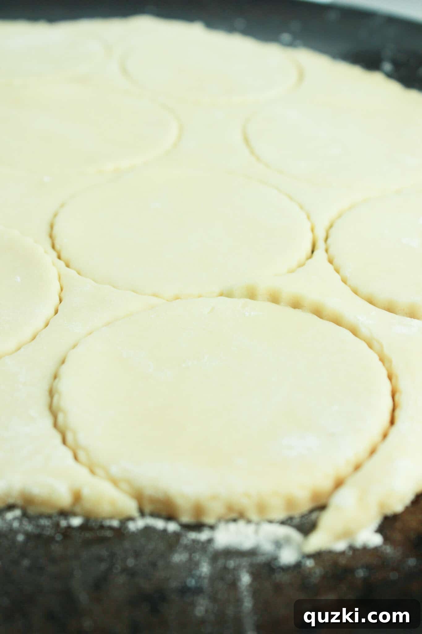 Effortless Cream Cheese Sugar Cookies 7 Rolling out and cutting round shapes from the sugar cookie dough.