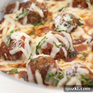 Finished meatball skillet with parmesan and basil.