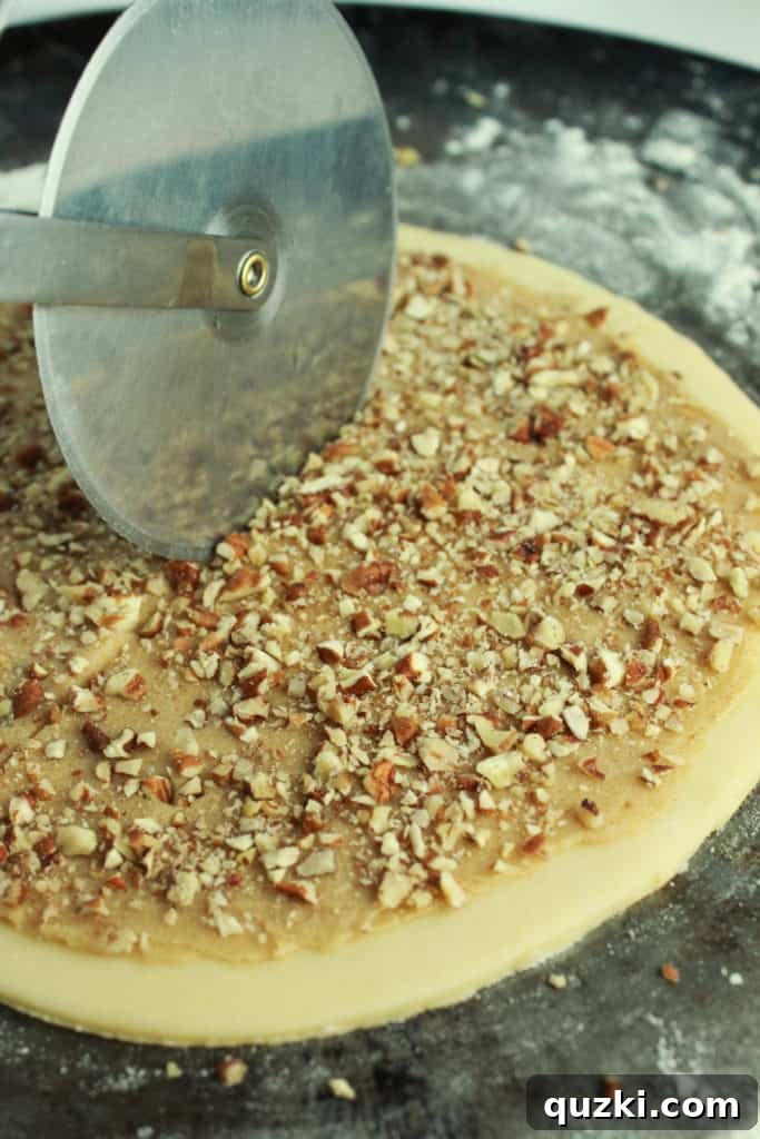 All-purpose flour being mixed into the wet ingredients of the cream cheese sugar cookie dough until just combined.